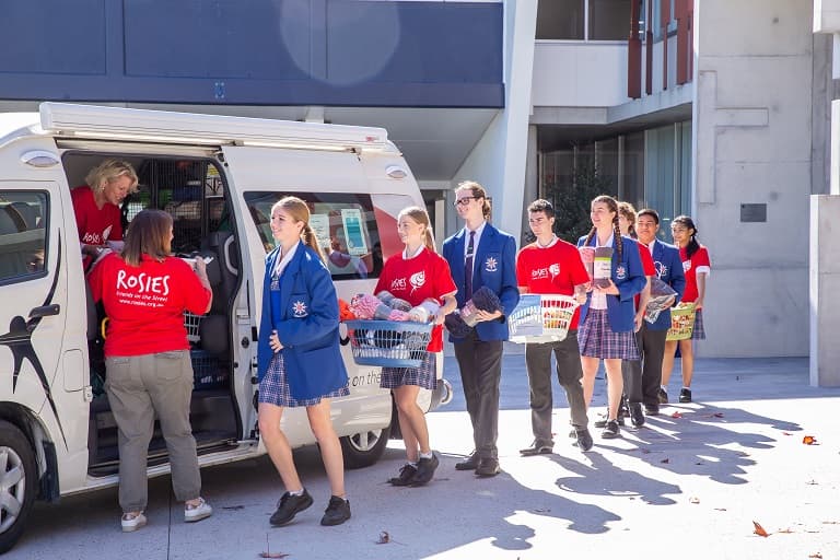 Aquinas College students supporting the Rosies community outreach program
